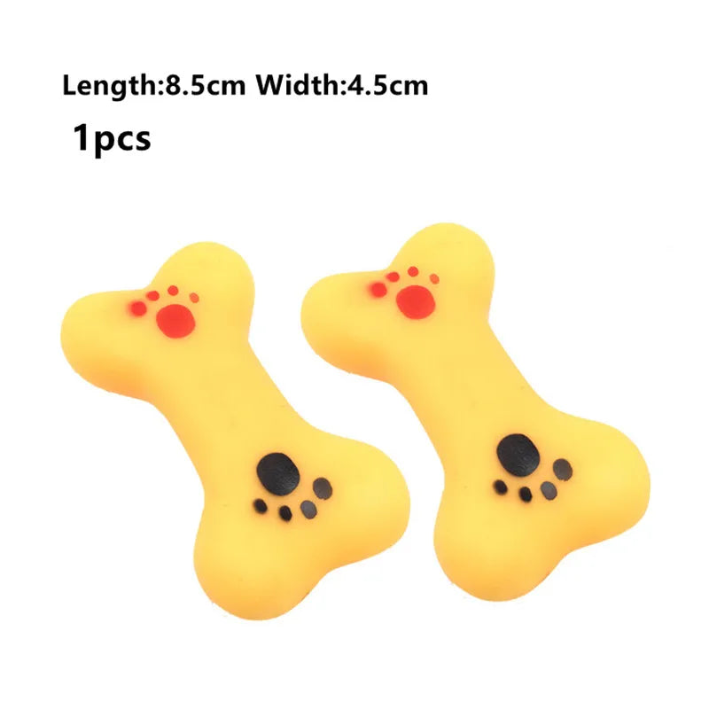 Two yellow dog toys shaped like bones with red and black accents on a white background.