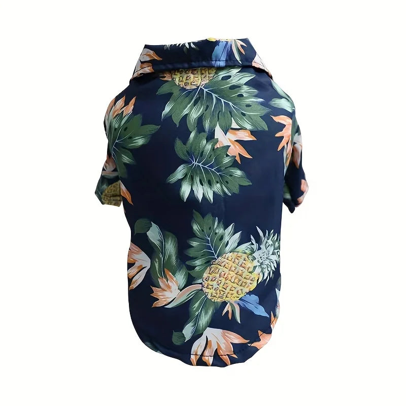 Navy blue pet coat with tropical leaf and pineapple pattern on a white background