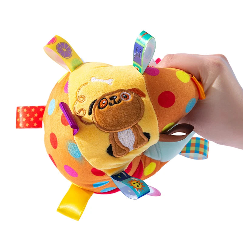Colorful dog toy with a cartoon character held by a hand on a white background